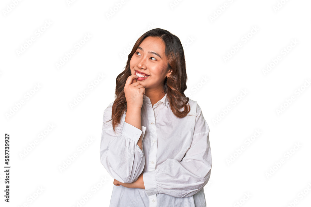 A young chinese woman relaxed thinking about something looking at a copy space. A young chinese woman relaxed thinking about something looking at a copy space.