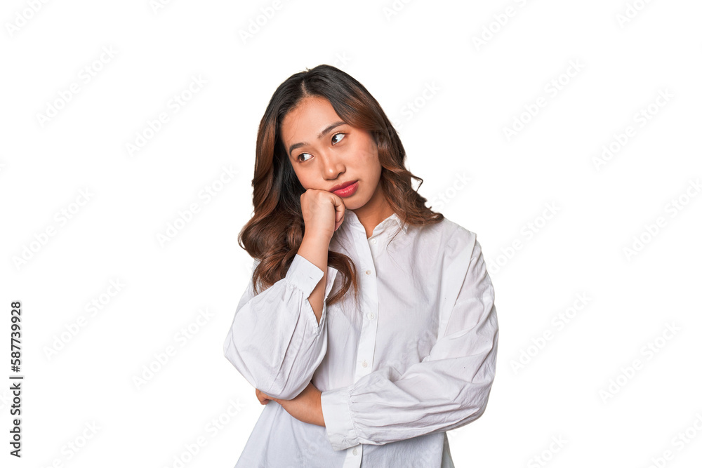 A young chinese woman who feels sad and pensive, looking at copy space. A young chinese woman who feels sad and pensive, looking at copy space.