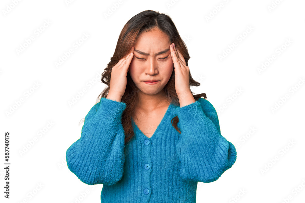 A young chinese woman touching temples and having headache. A young chinese woman touching temples and having headache.