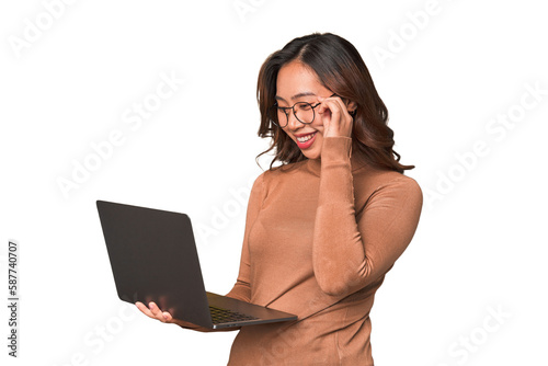 Canvas Print A young asian woman working with her laptop