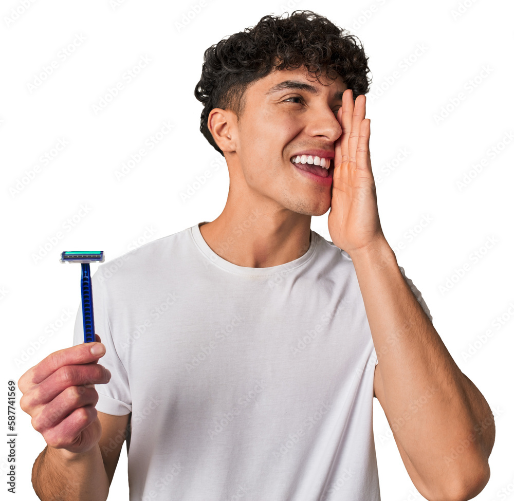 A young latin man holding a razor for shave shouting and holding palm near opened mouth. A young latin man holding a razor for shave shouting and holding palm near opened mouth.