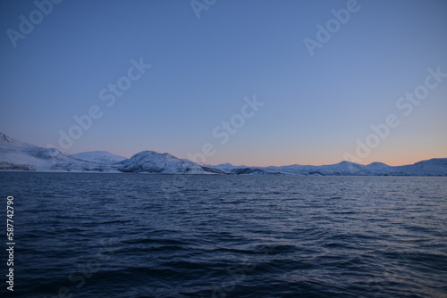 Mountains in the northern part of Norway, at the outlet to the ocean. Incredible sunset