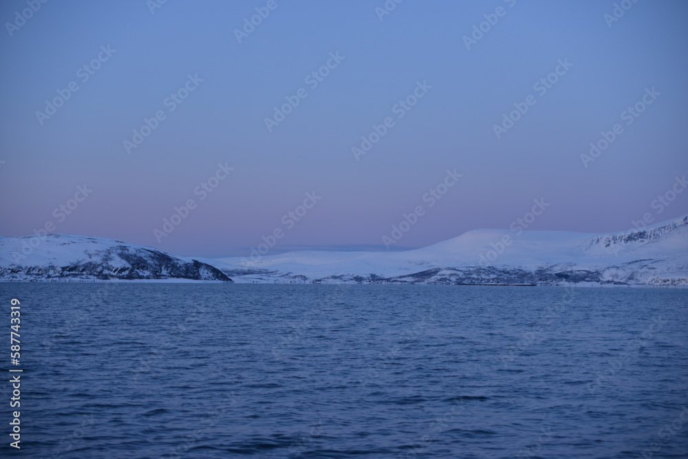 Mountains in the northern part of Norway, at the outlet to the ocean. Incredible sunset