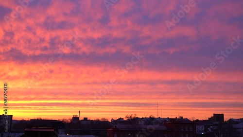 Beautiful evening blue sky at sunset with flaming bright light clouds. A warm summer evening at sunset. Bright sunset.