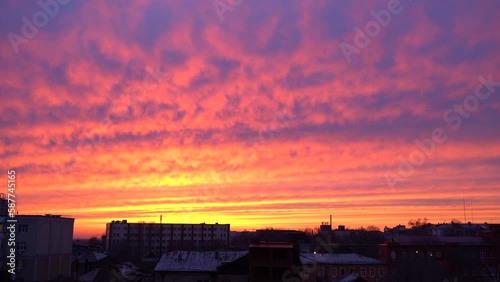 Beautiful evening blue sky at sunset with flaming bright light clouds. A warm summer evening at sunset. Bright sunset.