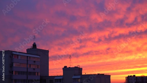 Beautiful evening blue sky at sunset with flaming bright light clouds. A warm summer evening at sunset. Bright sunset.