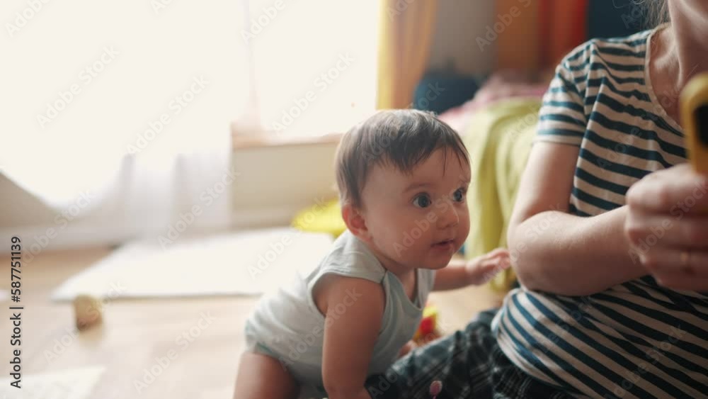 baby is learning to a stand up and wants to take her first steps. happy