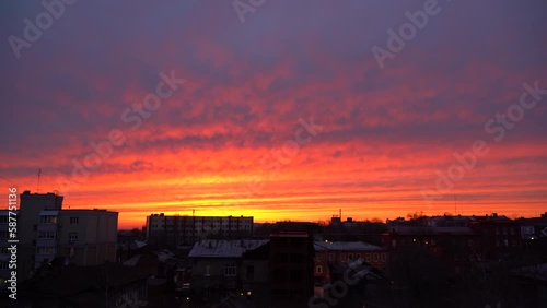 Beautiful evening blue sky at sunset with flaming bright light clouds. A warm summer evening at sunset. Bright sunset.