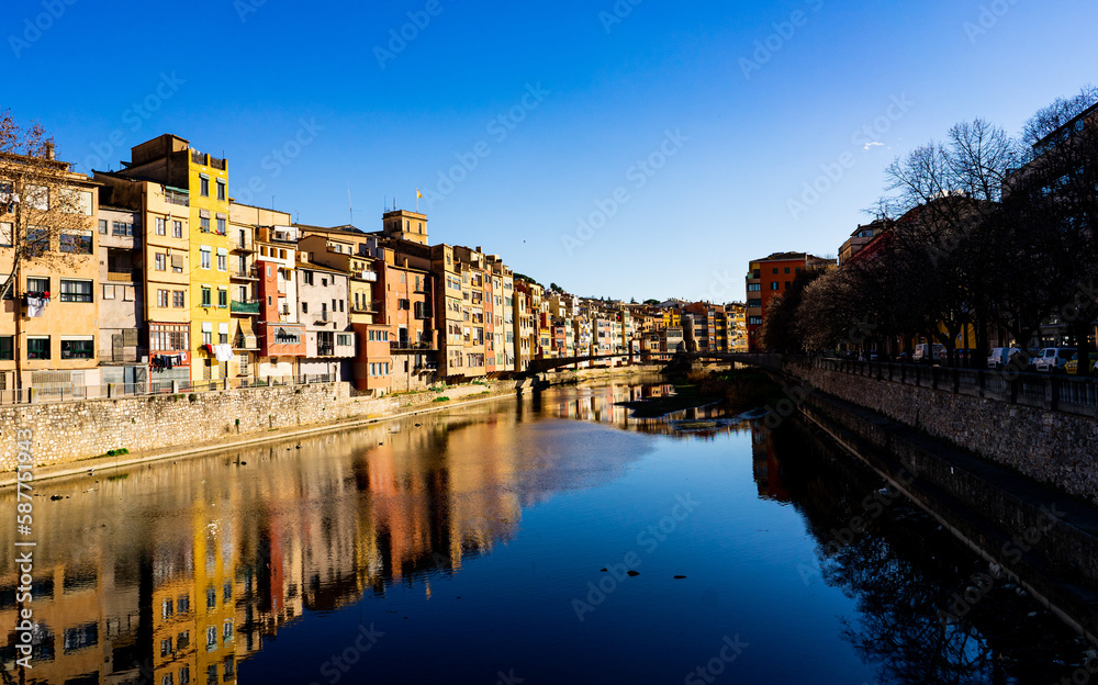 Colorfull city and houses with a river under a blue sky