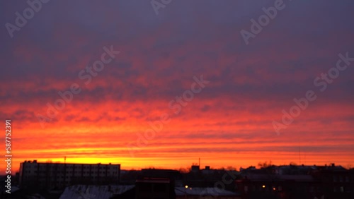 Beautiful evening blue sky at sunset with flaming bright light clouds. A warm summer evening at sunset. Bright sunset.