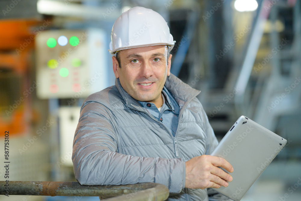 male industrial worker posing holding tablet male industrial worker posing holding tablet