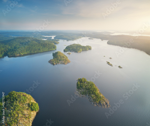 Island on lake during sunset, aerial view.