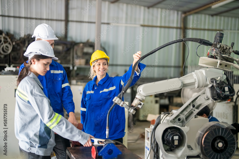 Engineer with robot in automotive parts factory Engineer with robot in automotive parts factory