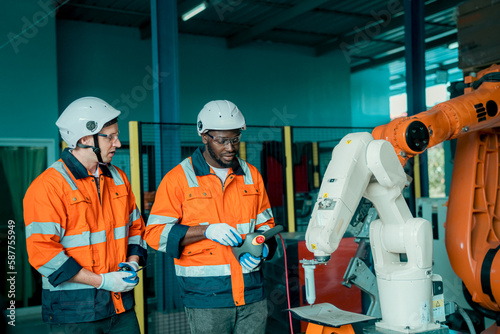 Industry 4.0: Engineer Monitoring Robotics Welding in Intelligent Factory. Digital manufacturing operation.