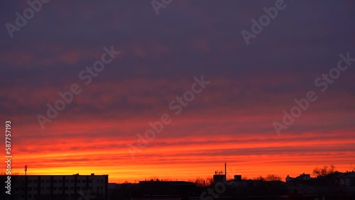 Beautiful evening blue sky at sunset with flaming bright light clouds. A warm summer evening at sunset. Bright sunset.