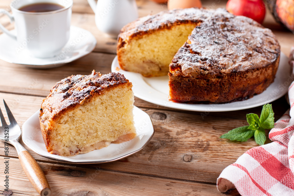 Clasic sponge cake with apples on table, selective focus. Homemade cake Clasic sponge cake with apples on table, selective focus. Homemade cake