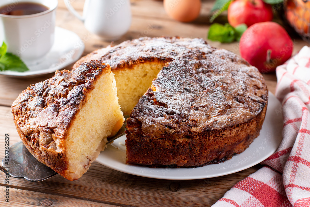 Sponge cake with apples on a table, selective focus. Homemade cake Sponge cake with apples on a table, selective focus. Homemade cake