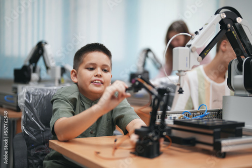 Children learning AI technology Robot with artificial intelligence system on its about the artificial intelligence during science lesson.