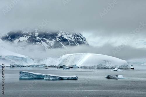 Icebergs with stunning mountainous backdrop of Wilhelmina Bay in Antarctica photo