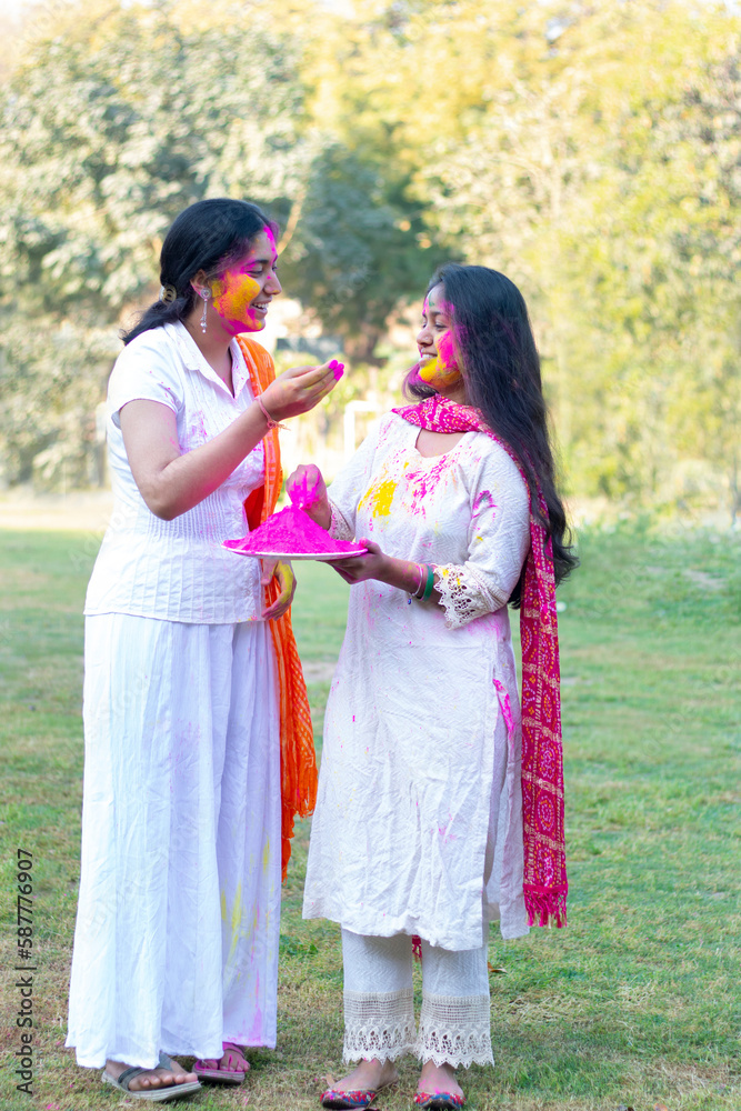 Two Indian teenage girls playing Holi during Holi Color festival Two Indian teenage girls playing Holi during Holi Color festival