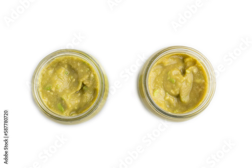 Baby puree with vegetable mix, broccoli, avocado in glass jar isolated on white, top view