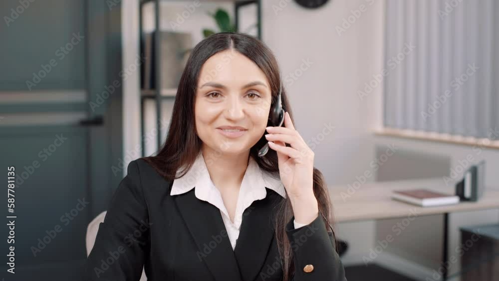 business woman call center working in office workplace. Attractive female employee worker sit on table wearing headset and use laptop computer talk to support customer in company. Looking at camera business woman call center working in office workplace. Attractive female employee worker sit on table wearing headset and use laptop computer talk to support customer in company. Looking at camera