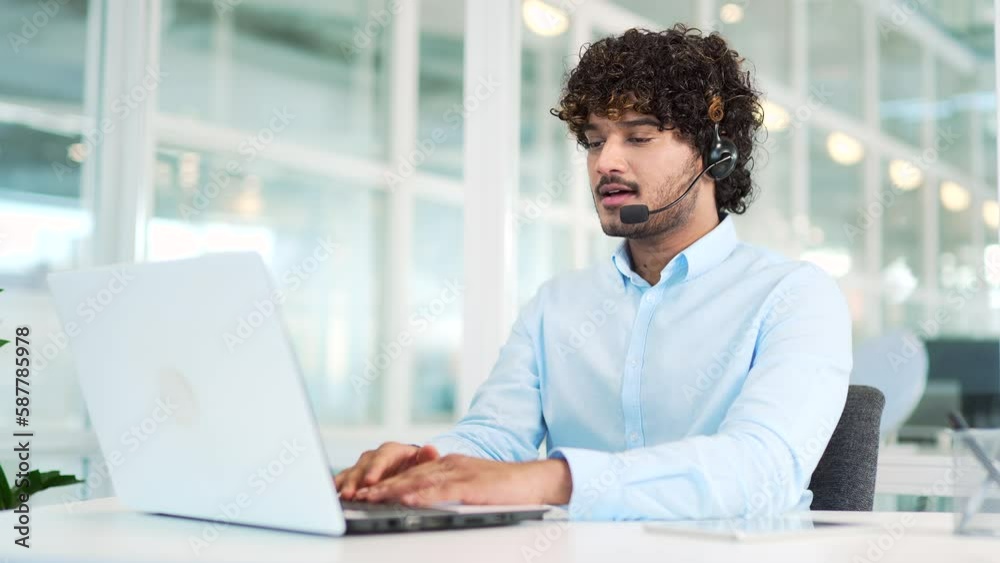Сorporate operator who works in the support service speaks on a video call using a laptop. Сall center agent in a wireless headset helps a customer with a complaint in a office by answering questions Сorporate operator who works in the support service speaks on a video call using a laptop. Сall center agent in a wireless headset helps a customer with a complaint in a office by answering questions