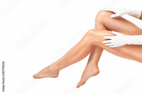 Slender, beautiful legs of a woman. Hair removal procedure on a woman’s body. Medical inspection and treatment of Telangiectasia. Phlebeurysm.