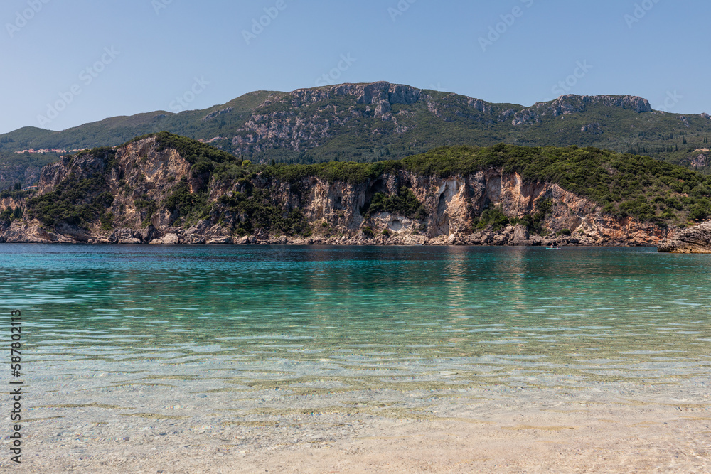 Panorama of beautiful Rovinia Beach with turquoise water and rocks during summer vacations, Corfu, Greece