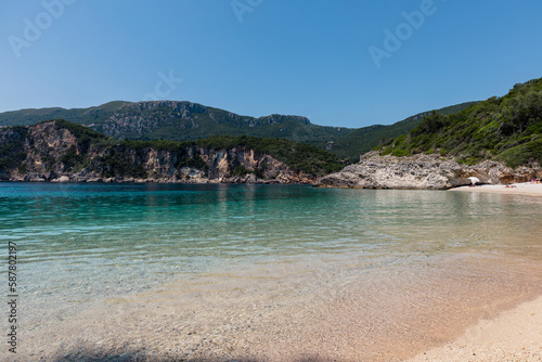 Panorama of beautiful Rovinia Beach with turquoise water and rocks during summer vacations  Corfu  Greece