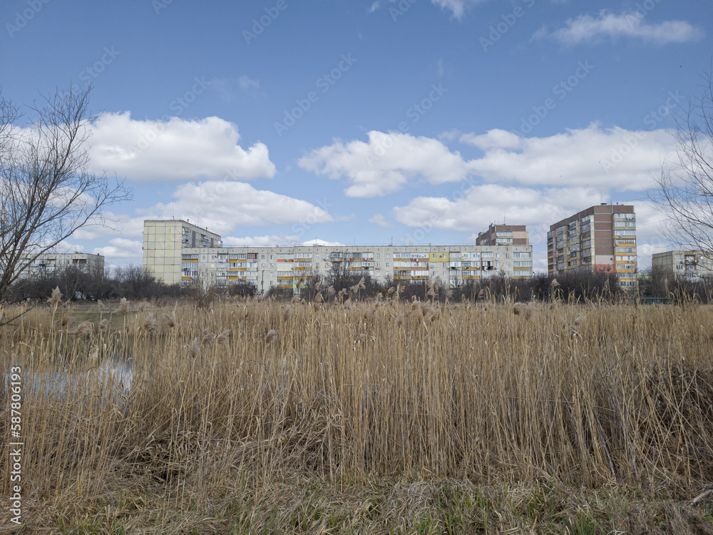 Prefabricated reinforced concrete apartment buildings on the shore of the river. Pereyaslav, Ukraine.