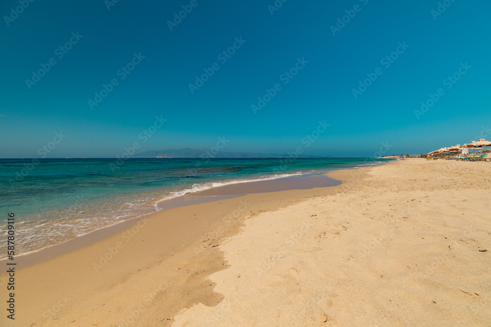 Beautiful empty beach on Naxos Island with turquoise Mediterranean sea 