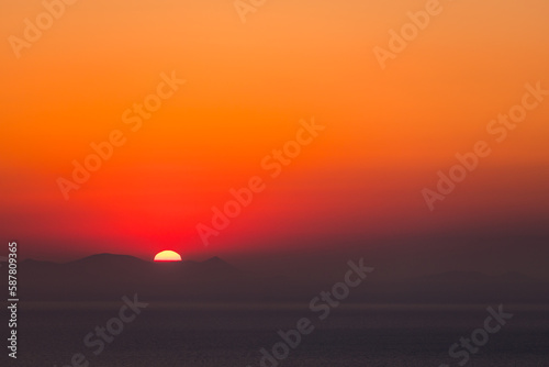 Santorini, Grece - July 23, 2020 -  Amazing red sunset over Oia and caldera of the Santorini island, Greece © Piotr