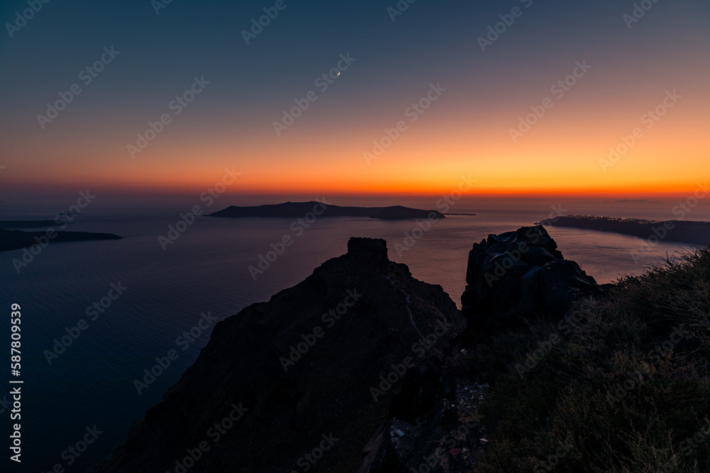 Santorini, Grece - July 23, 2020 -  Amazing red sunset over Oia and caldera of the Santorini island, Greece