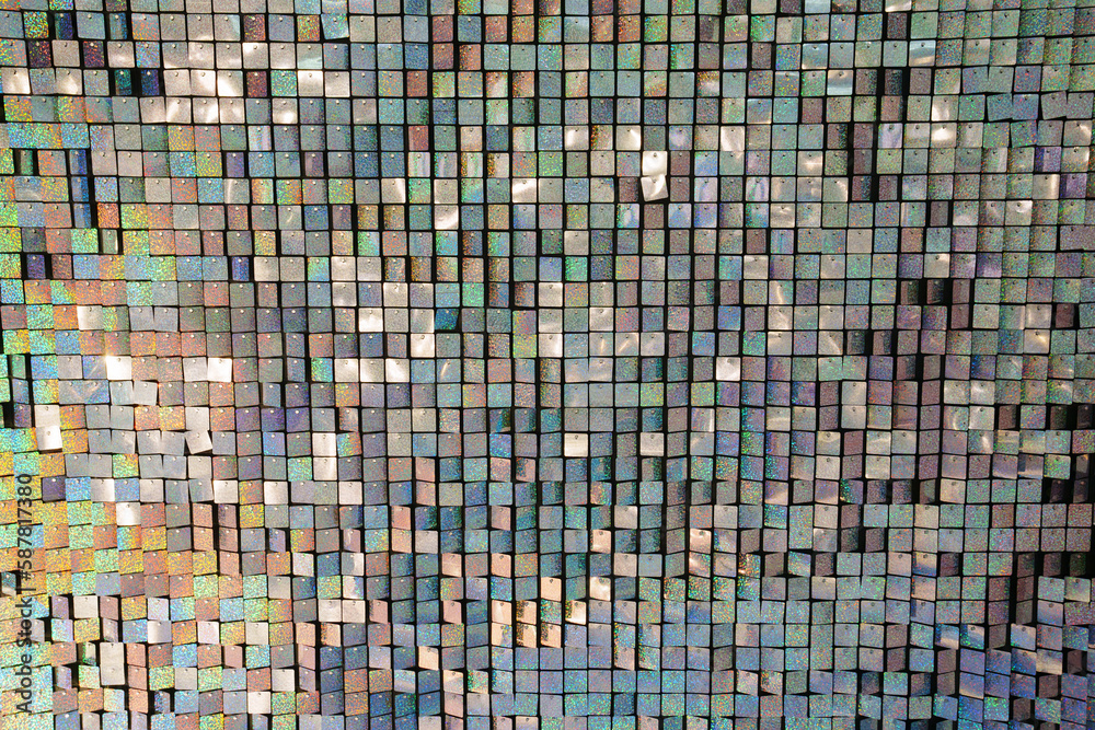 a wall of squares of shiny sequins. an element of decor for a holiday a wall of squares of shiny sequins. an element of decor for a holiday