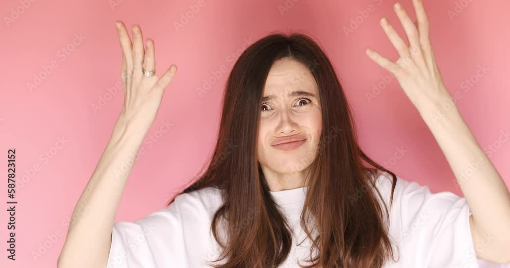 Displeased young woman spread hands, ask what and rolls her eyes isolated over pink background. Caucasian lady in displeasure, she is tired of situation, thinks how cant you still not understand. Displeased young woman spread hands, ask what and rolls her eyes isolated over pink background. Caucasian lady in displeasure, she is tired of situation, thinks how cant you still not understand.