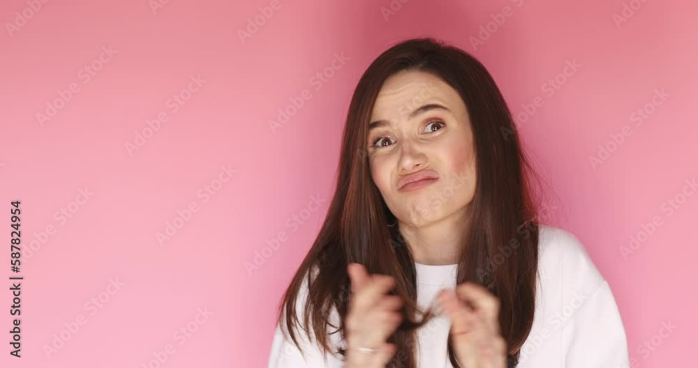Thinking process. Doubtful girl rubbing her hands, comparing decisions in head, search solution of problem, spread her hand not finding solution. Girl look confused isolated on pink background.