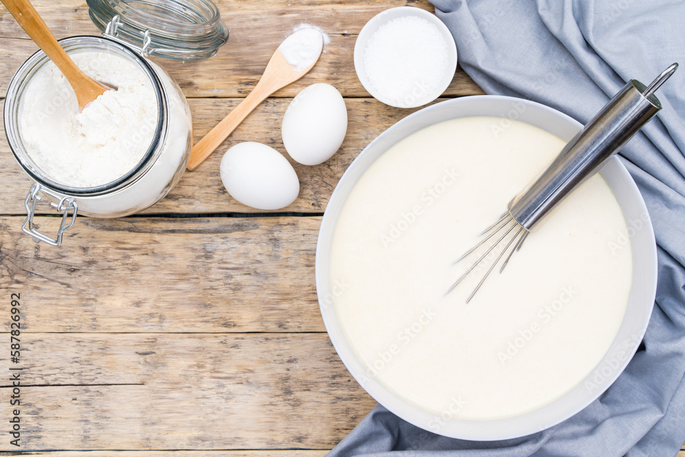 ingredients for making dough on a wooden table for pancakes, top view, copy space ingredients for making dough on a wooden table for pancakes, top view, copy space