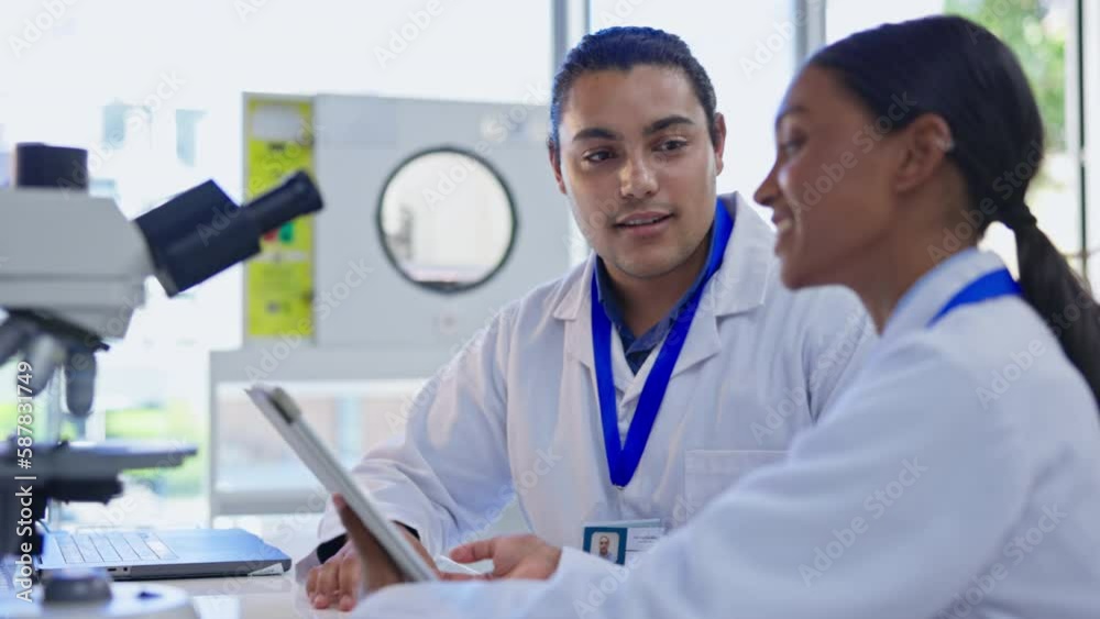 Scientist team, collaboration and tablet with lab staff, doctor research and microscope. Biotechnology, data review and science with man talking to laboratory worker in medical healthcare study Scientist team, collaboration and tablet with lab staff, doctor research and microscope. Biotechnology, data review and science with man talking to laboratory worker in medical healthcare study