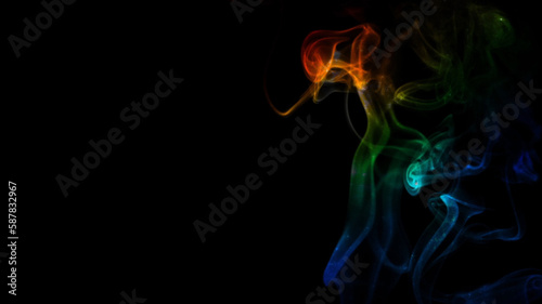 Rainbow Smoke Curls on Black Background features smoke rising and billowing with rainbow colors moving through a black atmosphere.