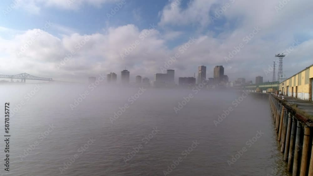Aerial Forward Shot Of Crescent City Connection Seen From Smoky River, Drone Ascending In City - New Orleans, Louisiana
