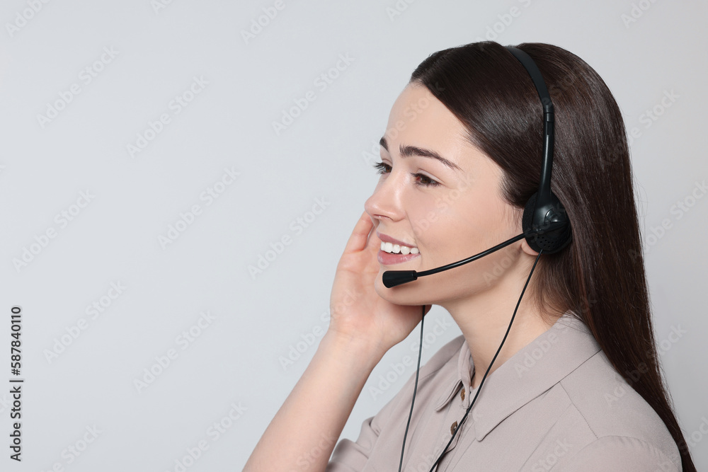 Hotline operator with modern headset on light grey background, space for text. Customer support Hotline operator with modern headset on light grey background, space for text. Customer support