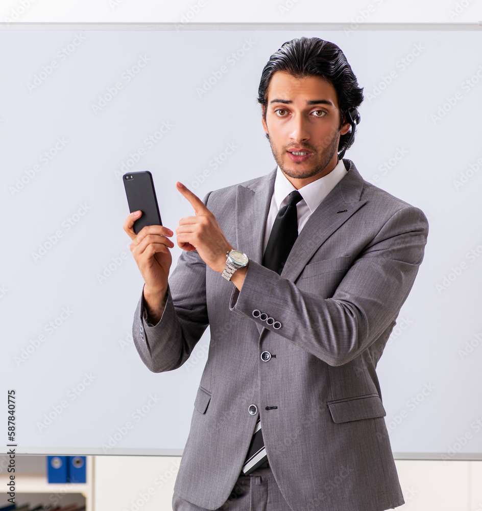 Young handsome businessman in front of whiteboard Young handsome businessman in front of whiteboard