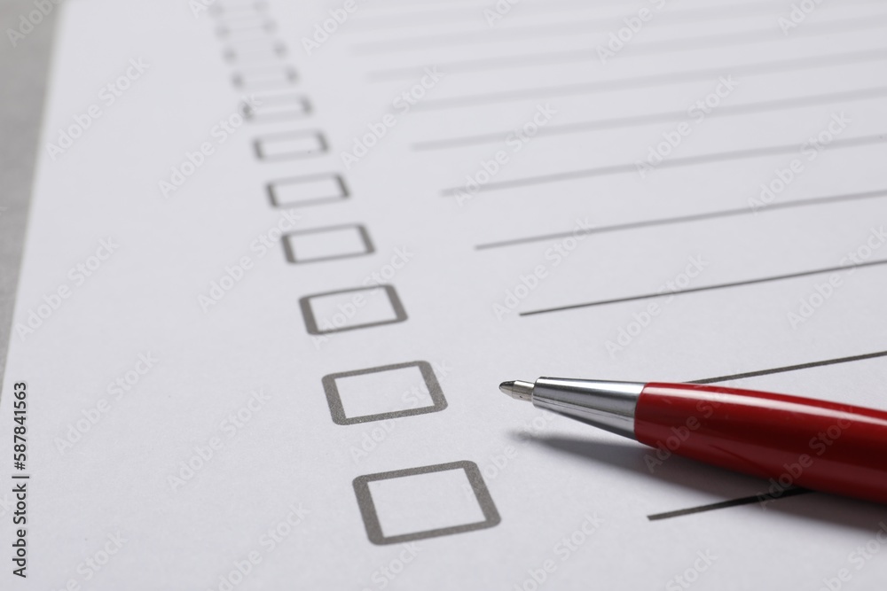 Paper sheet with checkboxes and pen on light grey table, closeup. Checklist Paper sheet with checkboxes and pen on light grey table, closeup. Checklist