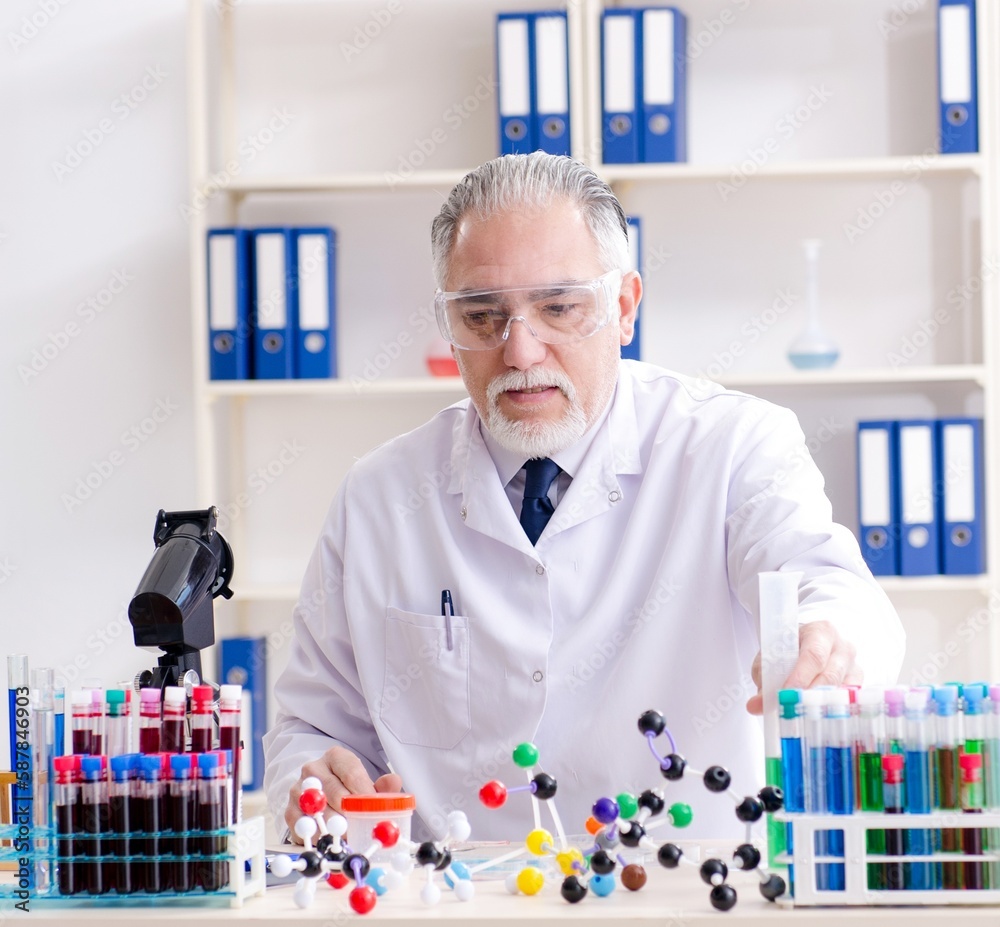 Old male chemist working in the lab Old male chemist working in the lab