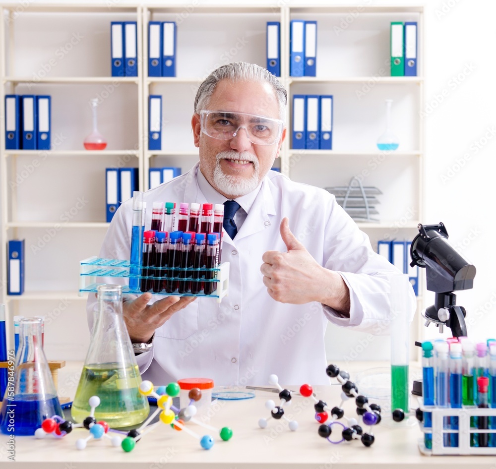 Old male chemist working in the lab Old male chemist working in the lab