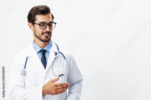 Male smile doctor in a white coat and eyeglasses and a stethoscope looks at the camera on a white isolated background, copy space, space for text, health © SHOTPRIME STUDIO