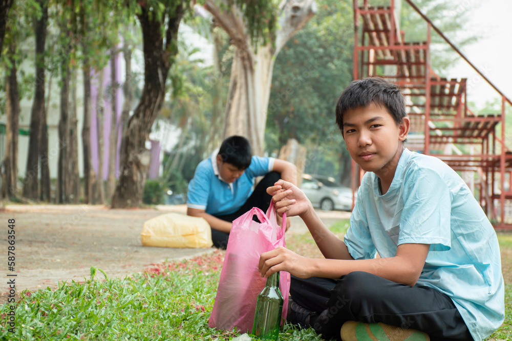 Asian boys in caucasian are resting near grandstand of school park during a volunteer job collecting trash after their annual school sports event, ideas for local environment care, community services. Asian boys in caucasian are resting near grandstand of school park during a volunteer job collecting trash after their annual school sports event, ideas for local environment care, community services.