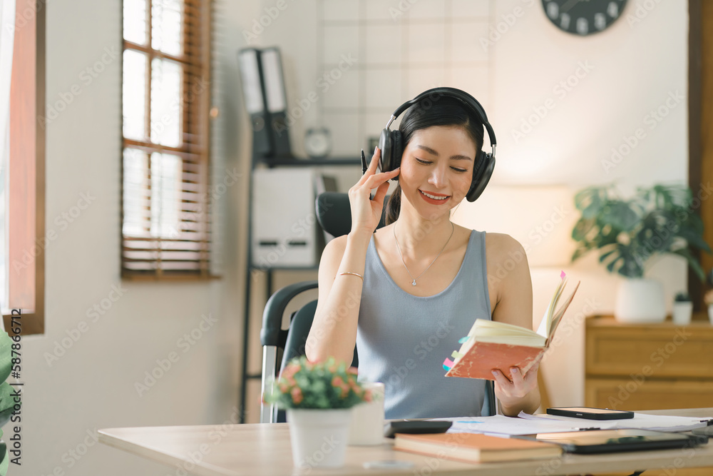 A millennial businesswoman of a startup working with financial report paperwork in her home office. The concept of financial advising teamwork and accounting is depicted. A millennial businesswoman of a startup working with financial report paperwork in her home office. The concept of financial advising teamwork and accounting is depicted.
