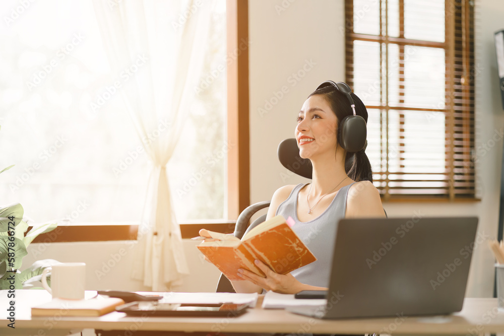 A millennial businesswoman of a startup working with financial report paperwork in her home office. The concept of financial advising teamwork and accounting is depicted. Warm tone A millennial businesswoman of a startup working with financial report paperwork in her home office. The concept of financial advising teamwork and accounting is depicted. Warm tone